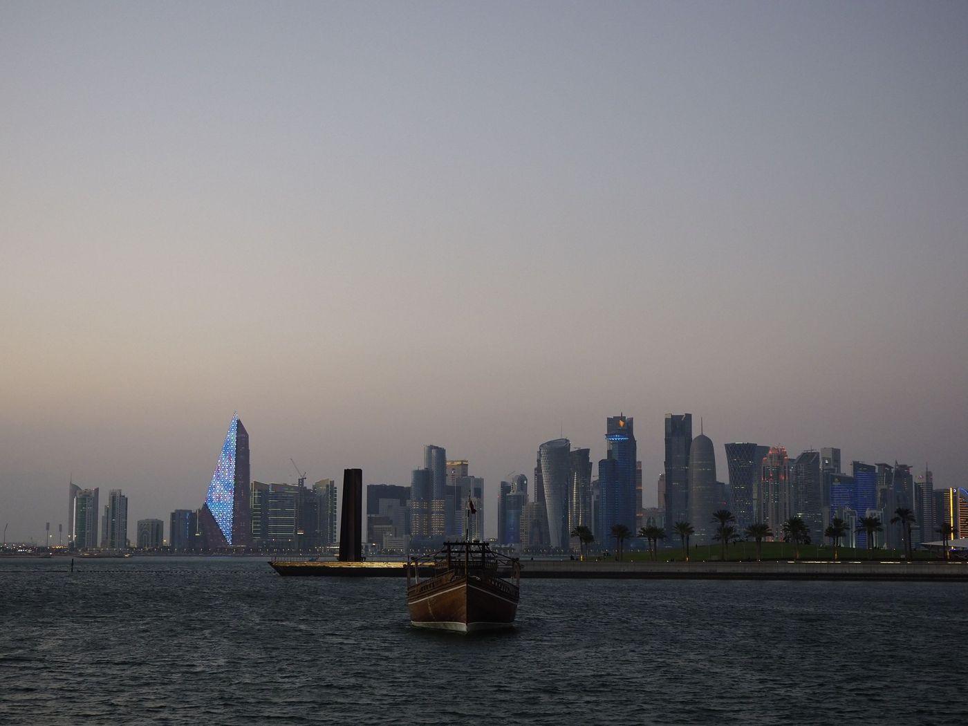 A working port waterfront under a clear sky